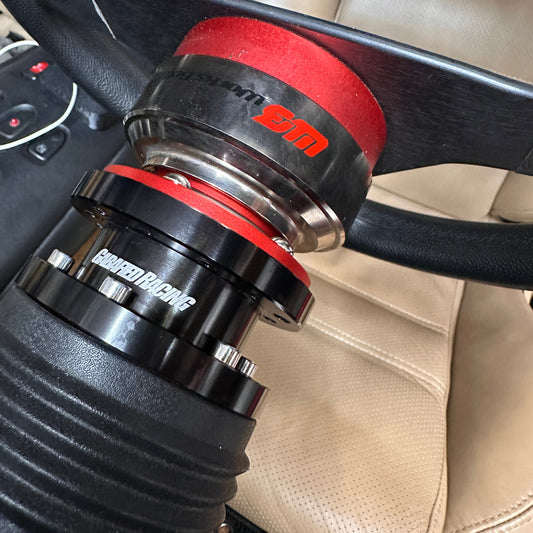 Close-up of a car steering wheel with a steering wheel spacer installed